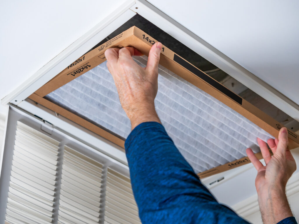 HVAC technician replacing a home air filter in Mountain View