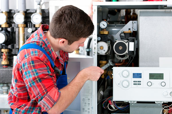 Heating technician repairing boiler controls in Mountain View