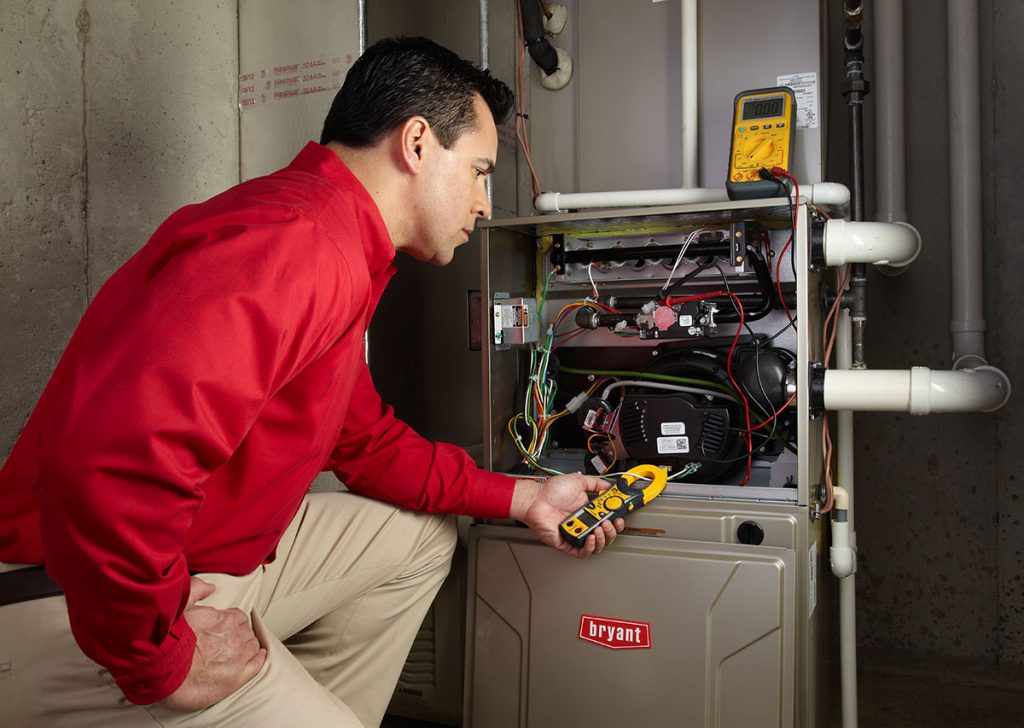 Heating technician diagnosing a furnace repair in Mountain View