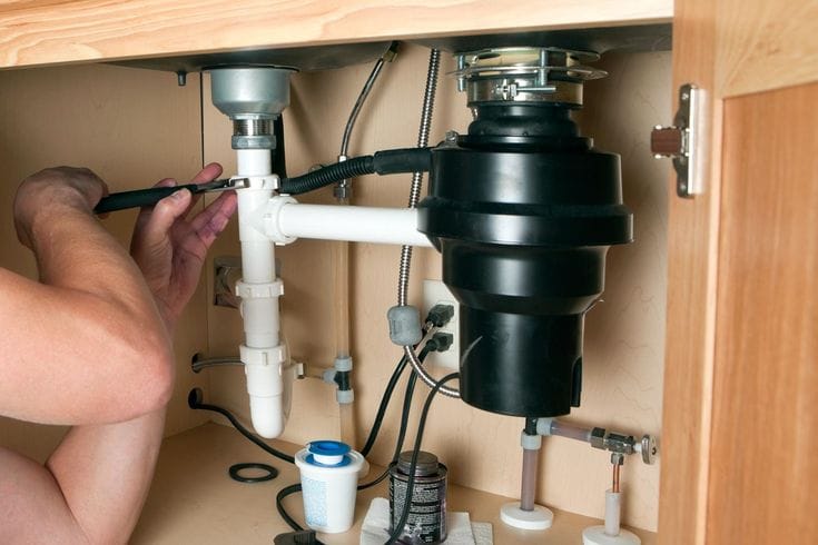 Plumber repairing a garbage disposal in Mountain View