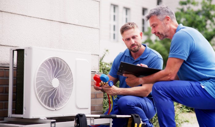 HVAC technicians installing an outdoor air conditioning unit in Mountain View